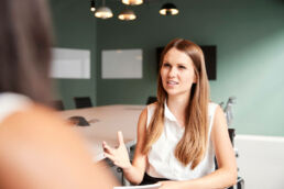 A woman receiving in person interview coaching.