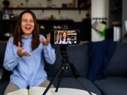 A woman recording an online interview after receiving help from a professional interview coach.